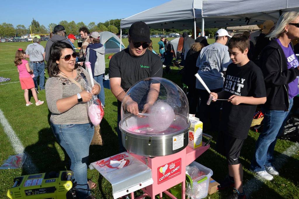 (Louis Krauss | Grays Harbor News Group) Naomi Avalos, left, Raul Avalos and Dryden Enzler make cotton candy at this years Relay For Life event in Hoquiam.