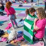 Breast cancer survivor Marisa Gefen, right, shares a moment with her daughter, Estella, 5, prior to the Reach Raise yoga event.