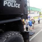 Emerson Elementary school students lineup to explore the back of an Aberdeen Police Department SWAT vehicle on Vehicle Day on June 13. (Hasani Grayson | Grays Harbor News Group)