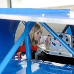 Emerson Elementary School student Taylor Sweers peers into Zack Simpsons race car on Vehicle Day on June 13. (Hasani Grayson | Grays Harbor News Group)