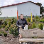 DAN HAMMOCK | GRAYS HARBOR NEWS GROUP                                Kim Roberts stands on the grounds of the Westport Winery. Behind her is the building that will hold the craft distillery she and her family are hoping to have up and running this fall.