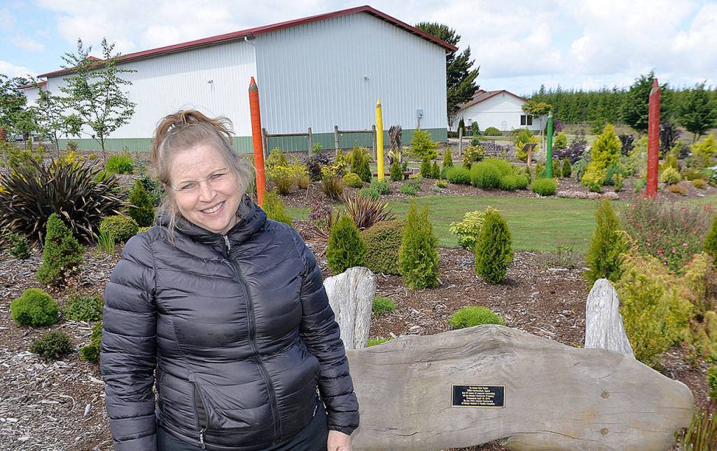 DAN HAMMOCK | GRAYS HARBOR NEWS GROUP                                Kim Roberts stands on the grounds of the Westport Winery. Behind her is the building that will hold the craft distillery she and her family are hoping to have up and running this fall.