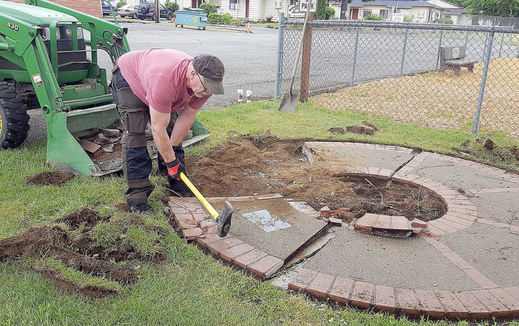 COURTESY MICHELLE AMES                                The existing Lindsey Baum memorial and its faded plaque were removed to make way for the new Lindsey Baum memorial garden at Beerbower Park in McCleary, which will be dedicated June 26. Arlee Rothwell, one of the many volunteers who worked on the garden, uses a sledgehammer to break up the old memorial.