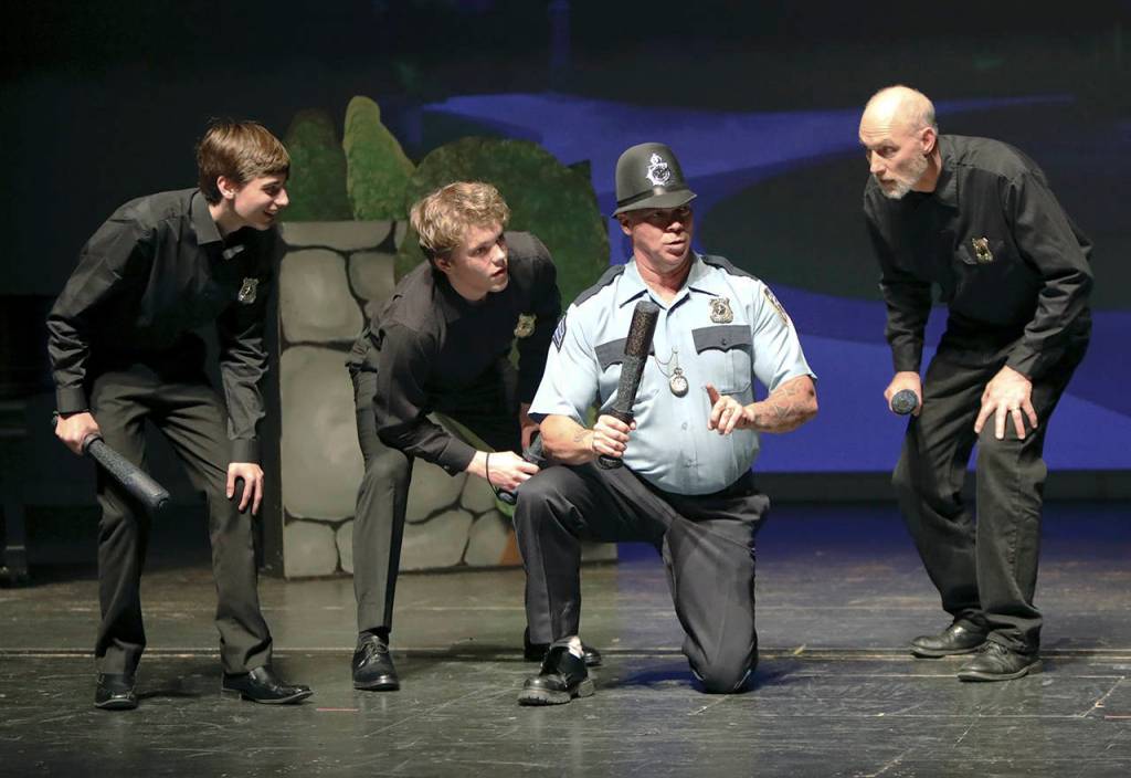 Keith J. Krueger                                The Sergeant of Police (Jeff Beard) instructs his men.