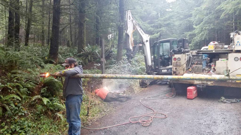 Photo courtesy Loren Hiner, City of Montesano                                A crew of workers from DC Farms in Elma works to repair a gate that somebody cut through to access a blocked road in Montesano-owned forest land. The repair required replacing an entire post and cost $1,186.