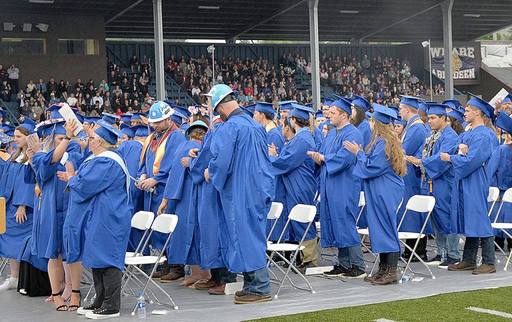 DAN HAMMOCK | GRAYS HARBOR NEWS GROUP                                Members of the 2019 Grays Harbor College graduating class applaud their supporters in the stands at Stewart Field during Fridays commencement ceremony.