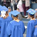 DAN HAMMOCK | GRAYS HARBOR NEWS GROUP                                Students walk onto Stewart Field in Aberdeen at the 2019 Grays Harbor College commencement ceremony Friday evening.
