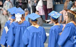 DAN HAMMOCK | GRAYS HARBOR NEWS GROUP                                Students walk onto Stewart Field in Aberdeen at the 2019 Grays Harbor College commencement ceremony Friday evening.