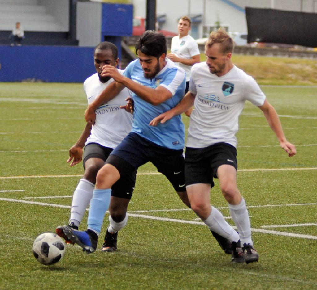 Grays Harbor Gulls midfielder Victor Corona, center, is sandwiched between Kirkland defenders Obi Esonu, left, and Lukas Isaacson during the first half of Saturdays Western Washington Premiere League game at Stewart Field in Aberdeen. (Ryan Sparks | Grays Harbor News Group)