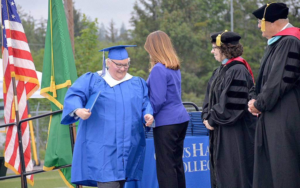 The first to cross the stage to get her diploma at the Grays Harbor College graduation ceremony Friday was part of the colleges first ever group of 21 to receive Bachelor in Applied Sciences degrees.