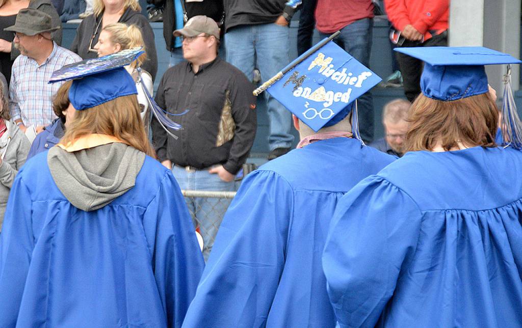 Students march in to the Grays Harbor College graduation ceremony at Stewart Field in Aberdeen Friday evening. About 200 were on hand to get their diplomas, part of the schools largest-ever graduating class.