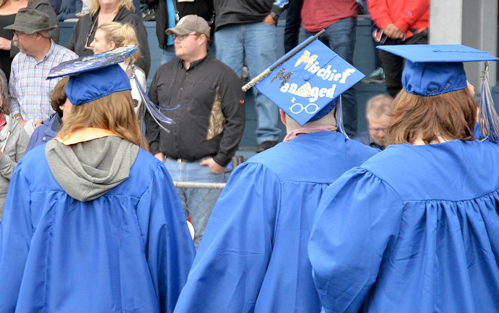 Students march in to the Grays Harbor College graduation ceremony at Stewart Field in Aberdeen Friday evening. About 200 were on hand to get their diplomas, part of the schools largest-ever graduating class.