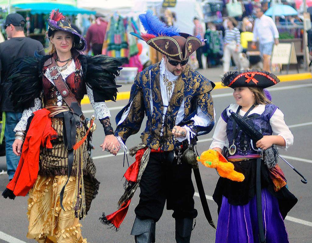 Heather Wulf, left, Michael Walther, center and Alina Mendoza-Wulf take in the festivities at Pirate Daze at the Marina in Westport. (Hasani Grayson | Grays Harbor News Group)