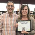 COURTESY MARAH GANNAWAY                                Cathy Anderson, receptionist and secretary at the Hoquiam School District office, retired July 3 after 25 years with the district. Superintendent Mike Villarreal presented her with the districts Spotlight on Excellence honor at the June 20 school board meeting. It reads: Hey lady, thank you for holding our district together with your warm smile, positive professionalism and dedication to improving the life of everyone lucky enough to meet you.
