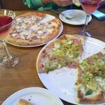 Pizza from Fat Olives: The pie on the right, the Belgio Dolce, features a white sauce base, mozzarella, pecorino romano, oregano, shaved fire-roasted brussel sprouts, calabrian chili oil, Molinari soppressata, local honey and crushed pistachios. One of the best pizzas ever and featured on the Food Networks Diners, Drive-ins and Dives.