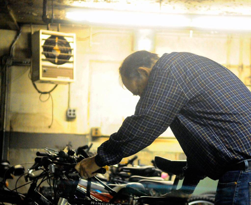 Hasani Grayson | Grays Harbor News Group                                Aberdeen Lions Club member Al Waters puts a bike into storage at the Grays Harbor Historical Seaport.