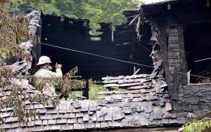 DAN HAMMOCK | GRAYS HARBOR NEWS GROUP                                Aberdeen Fire Department Assistant Chief Rich Malizia takes photos of where the house fire in the 900 block of Duffy Street Thursday morning was believed to have originated, in a third-story bedroom.
