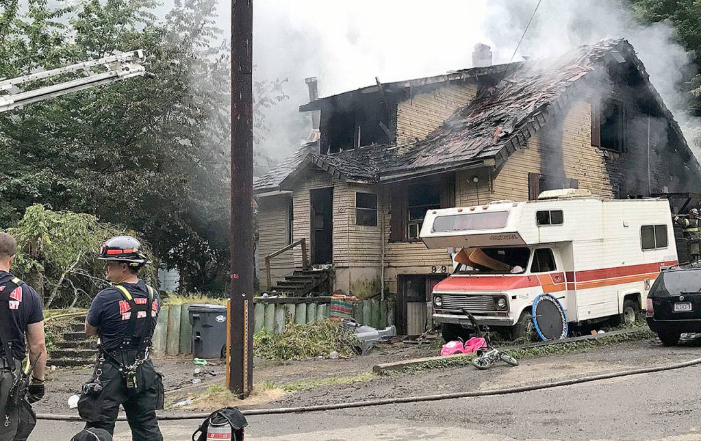 COURTESY DANNETTE HAGGERTY                                Firefighters tend to a house fire in the 900 block of Duffy Street in Aberdeen Thursday morning. Five of the seven occupants suffered varying degrees of burns. Two children and one adult were sent to Harborview Medical Center in Seattle for further treatment.