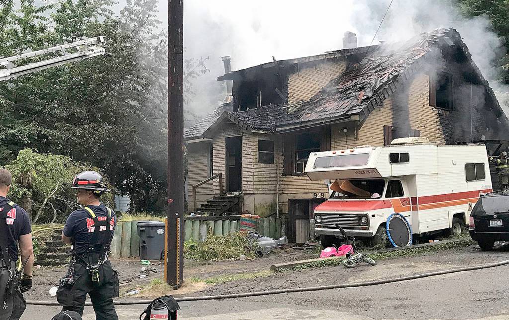 COURTESY DANNETTE HAGGERTY                                Firefighters tend to a house fire in the 900 block of Duffy Street in Aberdeen Thursday morning. Five of the seven occupants suffered varying degrees of burns. Two children and one adult were sent to Harborview Medical Center in Seattle for further treatment.