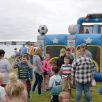 Kids wait for their turn at one of the inflatable slides.