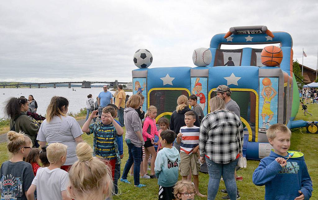 Kids wait for their turn at one of the inflatable slides.