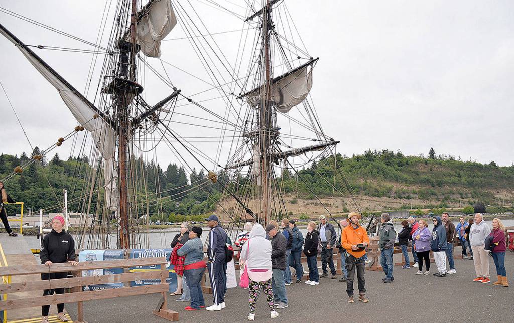 DAN HAMMOCK | GRAYS HARBOR NEWS GROUP                                Ticket holders wait in line to board the tall ship Lady Washington at the Grays Harbor Historical Seaport for the fireworks sail Thursday.
