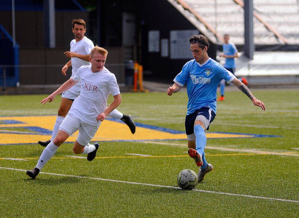 Grays Harbors Jordan Hamblin looks for room to run around midfield in the first half against Redmond on Saturday at Stewart Field. (Hasani Grayson | Grays Harbor News Group)