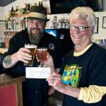 Scott D. Johnston | For Grays Harbor News Group                                Ocean Pours Taproom general manager Chris Shifman, left, and Green Lantern Lunch Program founder Phyllis Shaughnessy toast the pubs donation to the North Coast nonprofit organization, which feeds area kids during the summer. Shifman says each month, his Ocean Shores pub designates one of more of its 16 taps to give a 50-cent donation for each glass poured to a different local nonprofit. Junes donation for Green Lantern amounted to nearly $350, which he says was the largest amount since the business opened last winter.