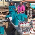 Courtesy photo                                Staff from Molina Healthcare of Washington and Sea Mar Community Health Centers pack reusable bags with healthy food items for Ocean Shores residents in need on June 29.