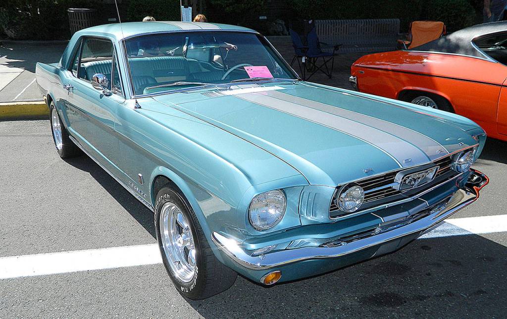 Photos by Dan Dugas                                ABOVE: This blue 1966 Ford Mustang owned by Chris Patterson of Montesano soaked up the sun at last years Midnight Cruizers Rod Fest in Aberdeen. BELOW: Steve and Vicki Frkorich of DuPont showed this lavender 1951 Ford Victoria convertible last year.