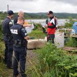 Louis Krauss | Grays Harbor News Group                                Joe Aitken, 24, receives a 72-hour vacate notice at his campsite along the Chehalis River in Aberdeen Thursday morning.