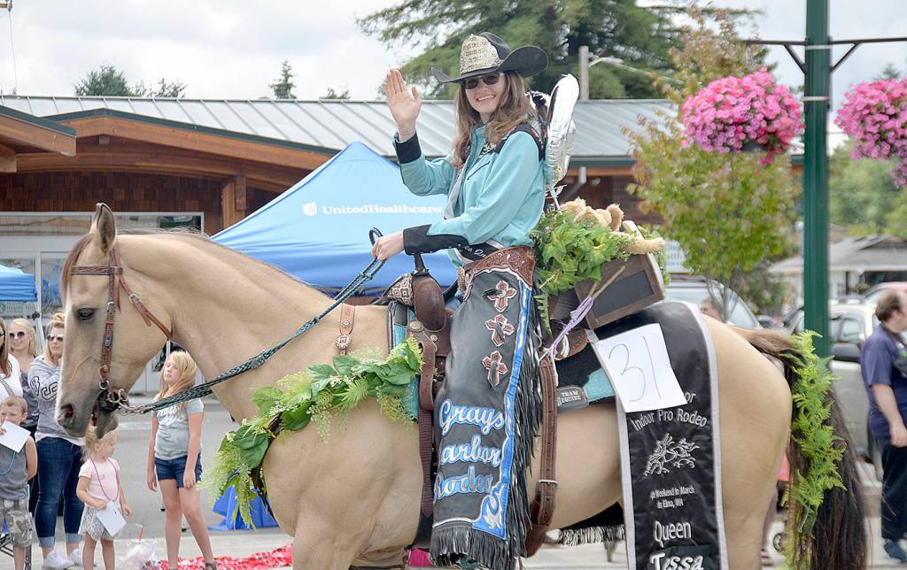 DAN HAMMOCK | GRAYS HARBOR NEWS GROUP                                Grays Harbor Mounted Posse Rodeo Queen Tessa Watson waves to the big crowd lining West Simpson during the McCleary Bear Festival parade Saturday.
