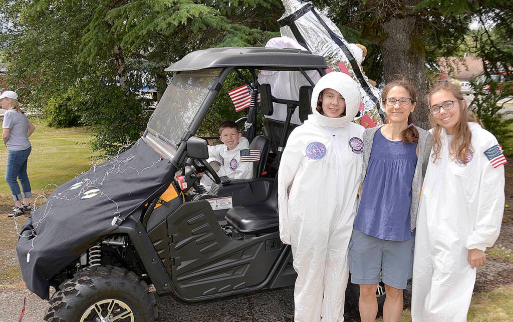 Photos by DAN HAMMOCK | GRAYS HARBOR NEWS GROUP                                ABOVE LEFT: Julia, Ella and Emelia Carnell went all out for their entry in Saturdays McCleary Bear Festival parade with this nod to the anniversary of the moon landing. Seated in the lunar rover is Zane Zabala. ABOVE RIGHT: The royal court for the 2019 McCleary Bear Festival winds its way through town during the parade Saturday.