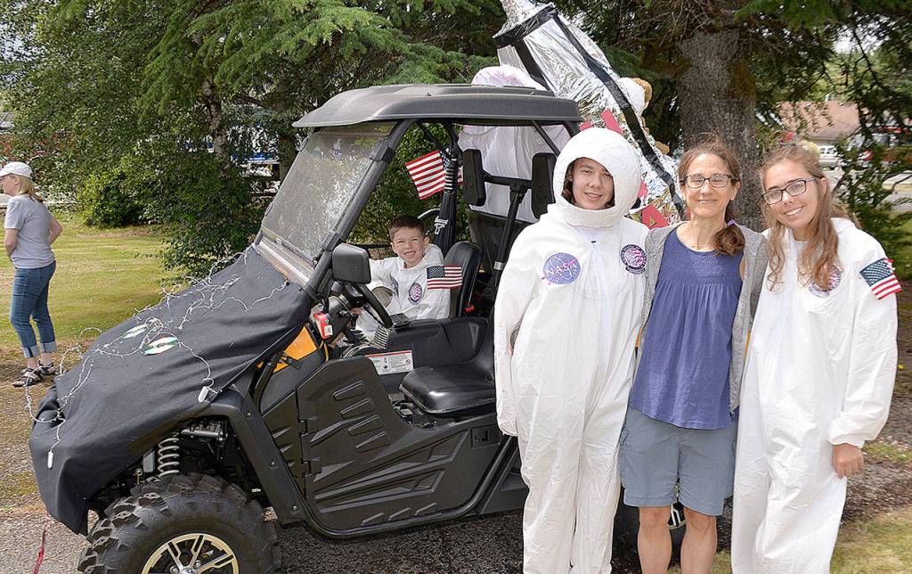 Photos by DAN HAMMOCK | GRAYS HARBOR NEWS GROUP                                ABOVE LEFT: Julia, Ella and Emelia Carnell went all out for their entry in Saturdays McCleary Bear Festival parade with this nod to the anniversary of the moon landing. Seated in the lunar rover is Zane Zabala. ABOVE RIGHT: The royal court for the 2019 McCleary Bear Festival winds its way through town during the parade Saturday.