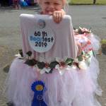 KAT BRYANT | GRAYS HARBOR NEWS GROUP                                Autumn Rose Nelson, 3, rode as Future Royalty in this decorated wagon, which received first place in the kiddie parade. Autumn is a cousin of Bear Festival Queen Koral Young.