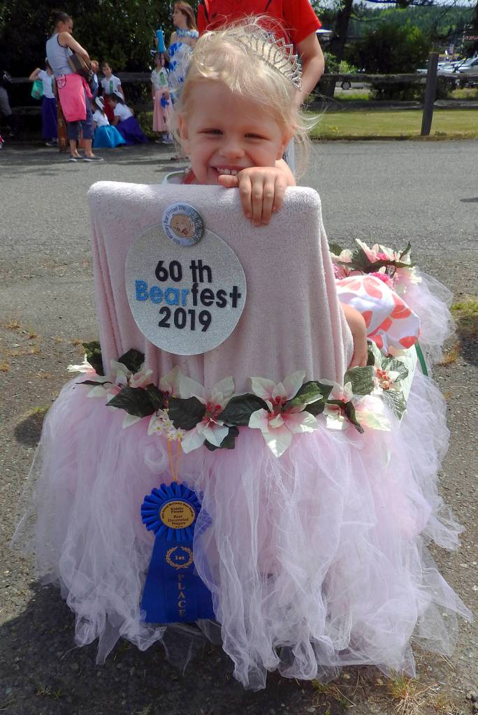 KAT BRYANT | GRAYS HARBOR NEWS GROUP                                Autumn Rose Nelson, 3, rode as Future Royalty in this decorated wagon, which received first place in the kiddie parade. Autumn is a cousin of Bear Festival Queen Koral Young.