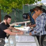 (Louis Krasuss | Grays Harbor News Group) Aberdeen Mayor Erik Larson, left, signs in Aaron and Jami Obi at the citys new overnight homeless facility in the City Hall parking lot Monday afternoon.