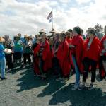 Klallam children sing a welcome song to canoes approaching Jamestown Beach on Tuesday. (Keith Thorpe/Peninsula Daily News)