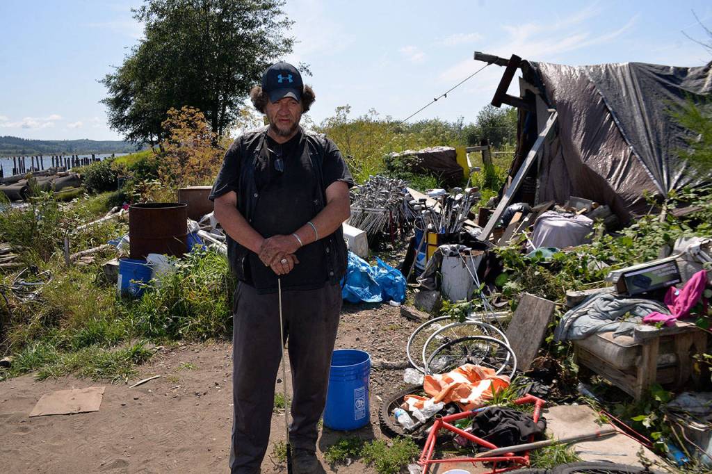 Leonard Vervalen, stands next to his shelter along the Chehalis River in Aberdeen shortly before it was knocked down by excavators.