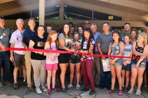 (Courtesy YMCA of Grays Harbor) Camp Bishop attendees cut a ribbon at the new dining hall.