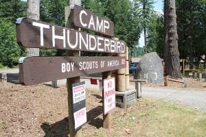 The Boy Scouts of Americas Camp Thunderbird at Summit Lake in Thurston County has played host to Pioneer Rock since the 1990s. Two area men hope to move the 29-ton granite rock  seen Wednesday, July 24, 2019, to the right of the sign  to the rest area east of Elma. (Michael Lang | Grays Harbor News Group)