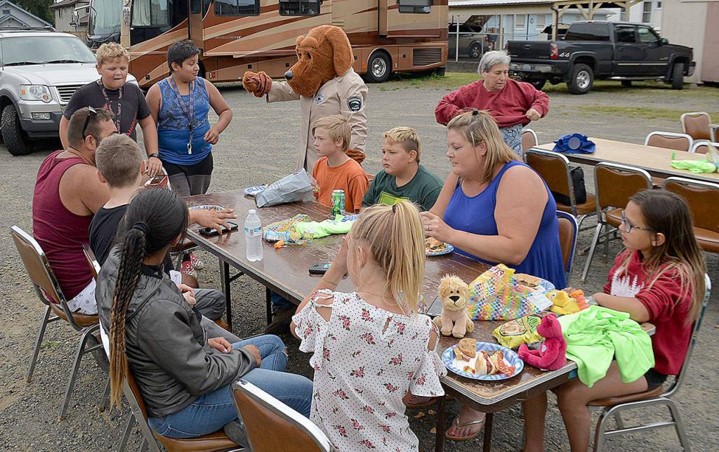 DAN HAMMOCK | GRAYS HARBOR NEWS GROUP                                There were nine official National Night Out block parties in Hoquiam Tuesday evening. Here McGruff the Crime Dog stops by one at the Hoquiam Elks Lodge as families enjoy the hot dogs and other treats provided by the lodge.