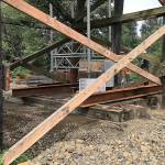 COURTESY DEPARTMENT OF TRANSPORTATION                                Crews from Rognlins Inc. shore up the State Route 107 Chehalis River bridge south of Montesano. The roadway, closed Tuesday morning after construction crews found the timber bridge support pilings on the south approach had settled up to six inches, is on track to reopen at 8 a.m. Friday.