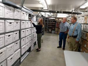 Courtesy John Shaw                                Digital Projects Archivist Mary Hammer, left, goes through artifacts recovered from the Aberdeen Museum of History archives in Olympia, while Aberdeen historian George Donovan looks on with State Archivist Steve Excell.