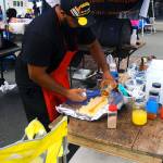 Mark Starks prepares food at Summerfest on Saturday. (Hasani Grayson | Grays Harbor News Group)