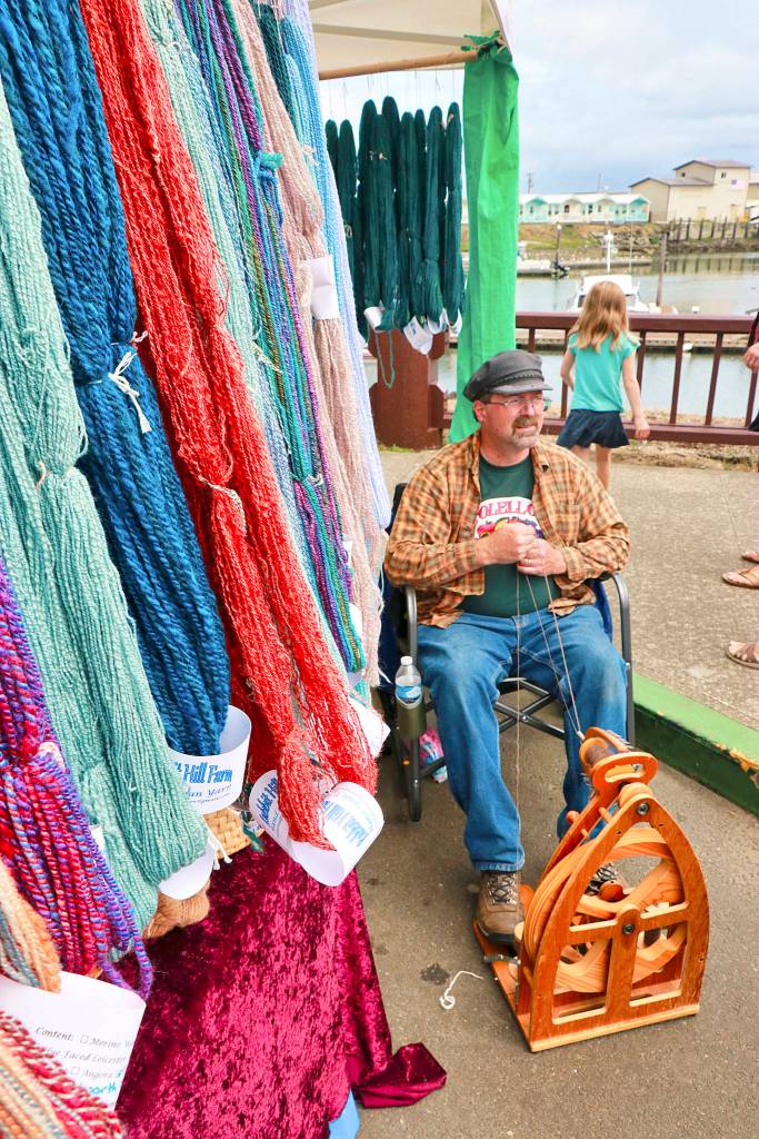 Doug Strausbaugh spins some yarn at his booth for Rabbit Hill Farm.