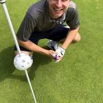 Nick Farrer crouches near the 10th hole after recording an ace on Wednesday, Aug. 14, at Highland Golf Course. (Submitted Photo)