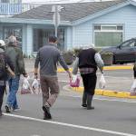 The results of a productive combination fishing trip out of the Westport Marina earlier this month, anglers making way to the public parking lots with bags of salmon and rockfish filets. (DAN HAMMOCK | GRAYS HARBOR NEWS GROUP)