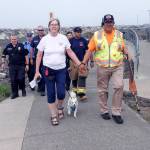 Kat Bryant | Grays Harbor News Group                                Charlcie Koster walks the final steps with Glenn from the Westport Observation Tower to the beach at Half Moon Bay. Pictured with them, from left, are Westport Police Cpl. Kevin Chaufty and, representing the South Beach Regional Fire Authority, EMR Chris Timm, Capt. Darin Vander Veur, firefighter/EMT Paul Barrow and Lt. Eric Delgado.