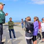Photos by Patrick Webb                                 Volunteer host Bob Sargent, left, explains the safety rules to the families who were first in line to take a tour when the North Head Lighthouse reopened Aug. 22.